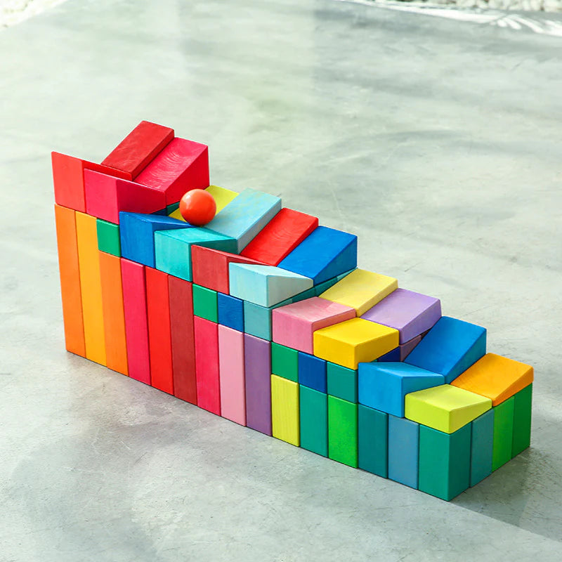 **pre-order (ships in 2-3 weeks)**30 pcs stained wooden sloping blocks in primary rainbow colors with storage tray